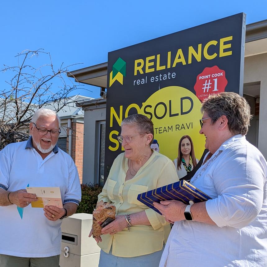 Trish Moore with clients at sold board