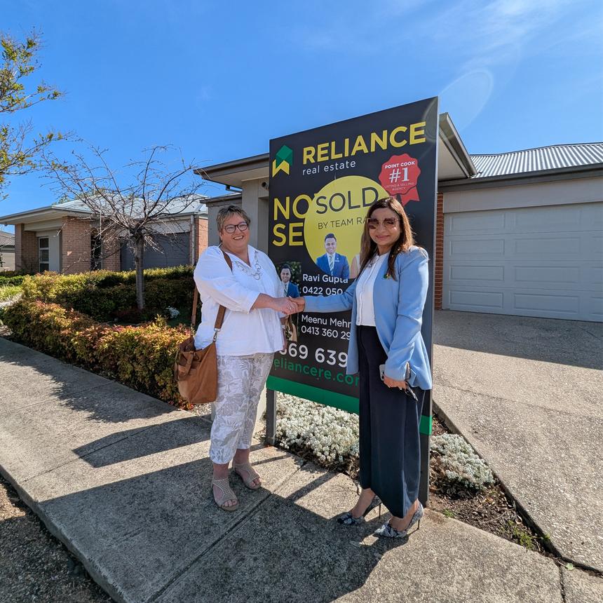 Trish with a real estate agent celebrating a sale